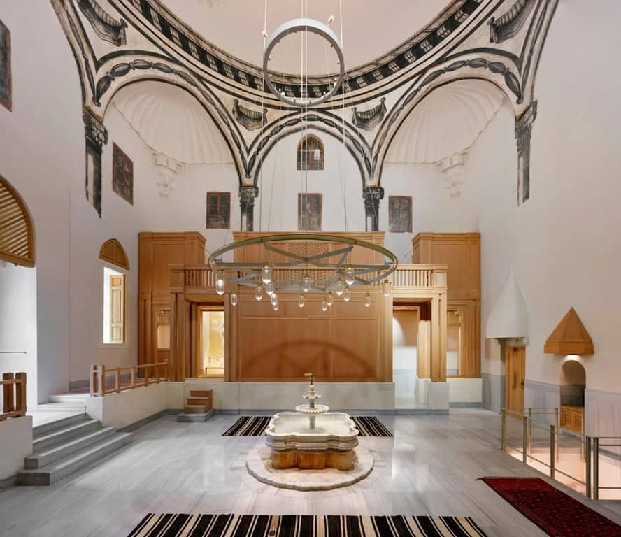 High-ceiling Ottoman hammam hall with grand chandelier and marble basins 🕌