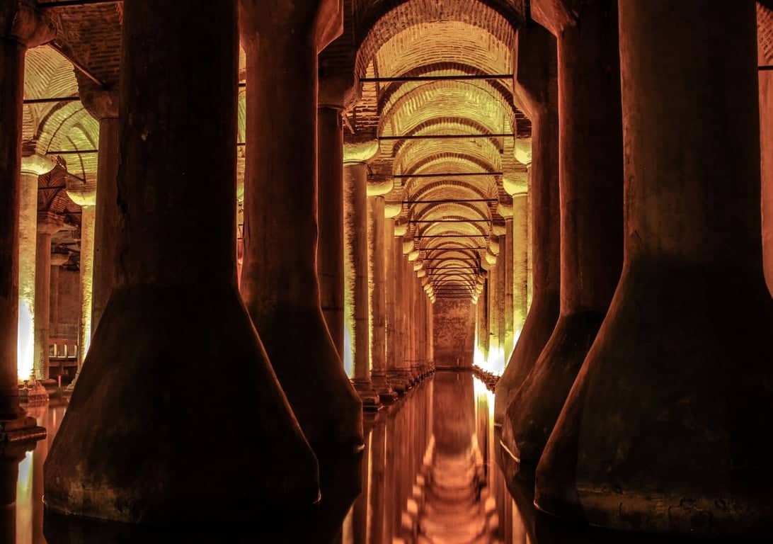 Dim corridor of illuminated pillars inside the Basilica Cistern