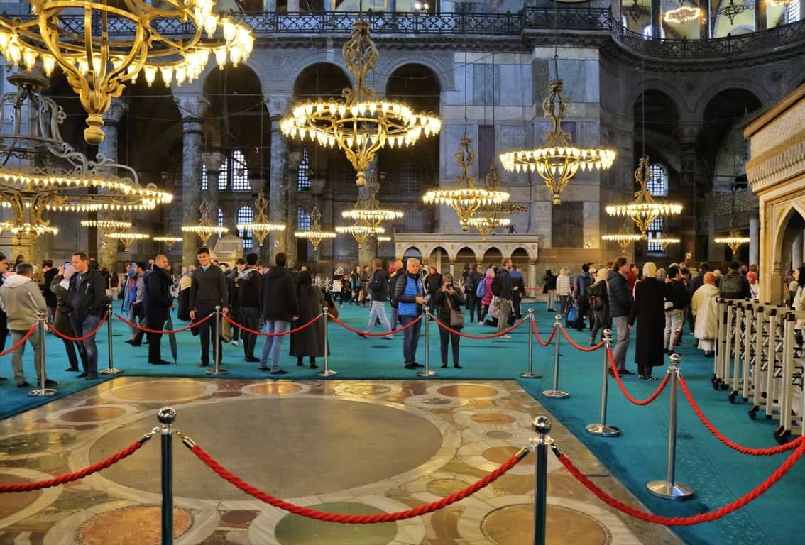Queue area inside Hagia Sophia with chandeliers as guests start the guided orientation