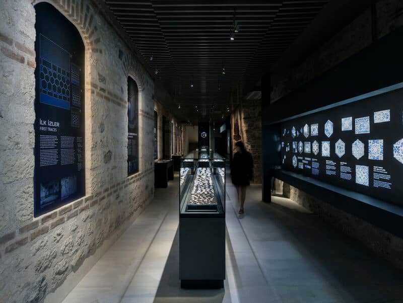 Museum-style exhibition corridor with historic hammam artifacts on display