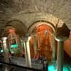 Wide hall of the cistern with glowing arches and reflections