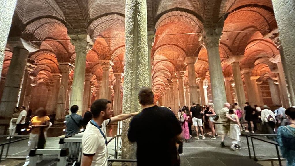Small group with a licensed guide among towering cistern columns